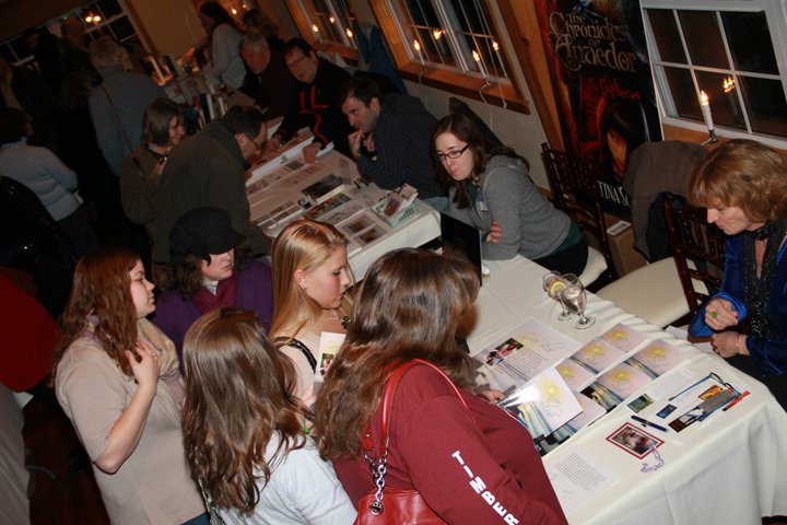 Looking at the different books for sale at the Author's Night at the Vineyard.
